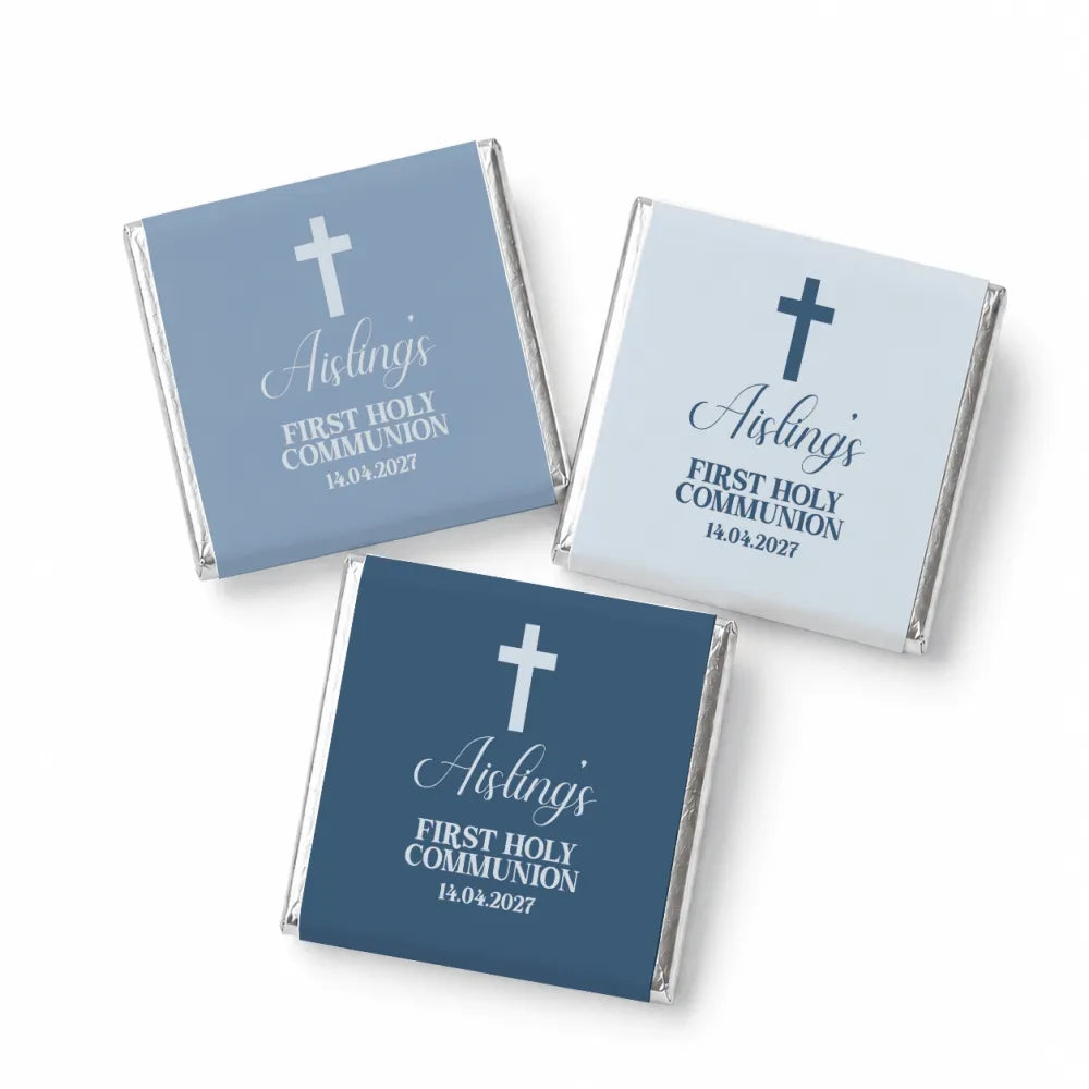 Three mini neapolitan chocolates wrapped in blue and light gray foil with white crosses for holy communion favors