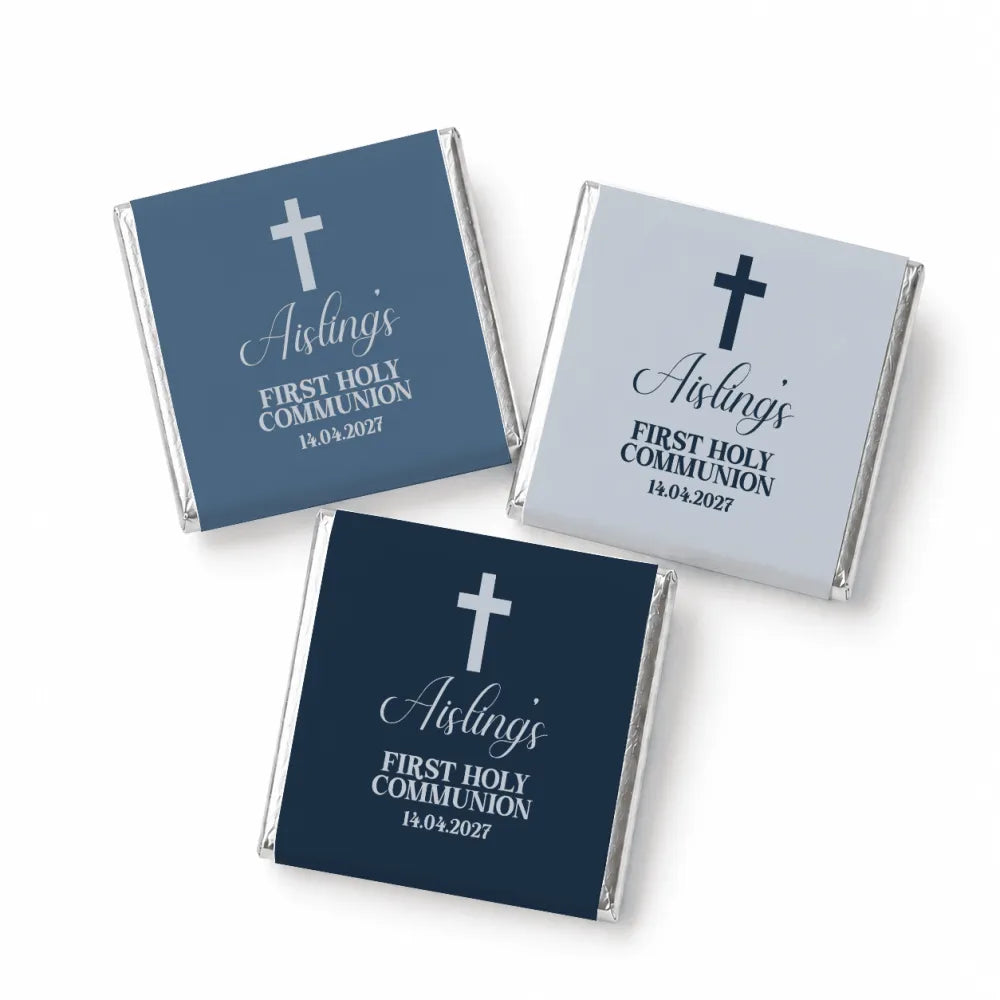 Three mini neapolitan chocolates wrapped in navy blue and gray foil with white cross and aisling holy communion text