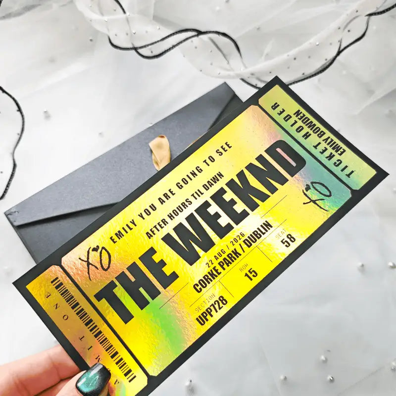 Ticket-style invitation for a concert featuring 'The Weekend' with a hand holding it.