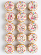 Cute pink and white edible cupcake toppers featuring adorable cartoon kittens for birthday cupcakes