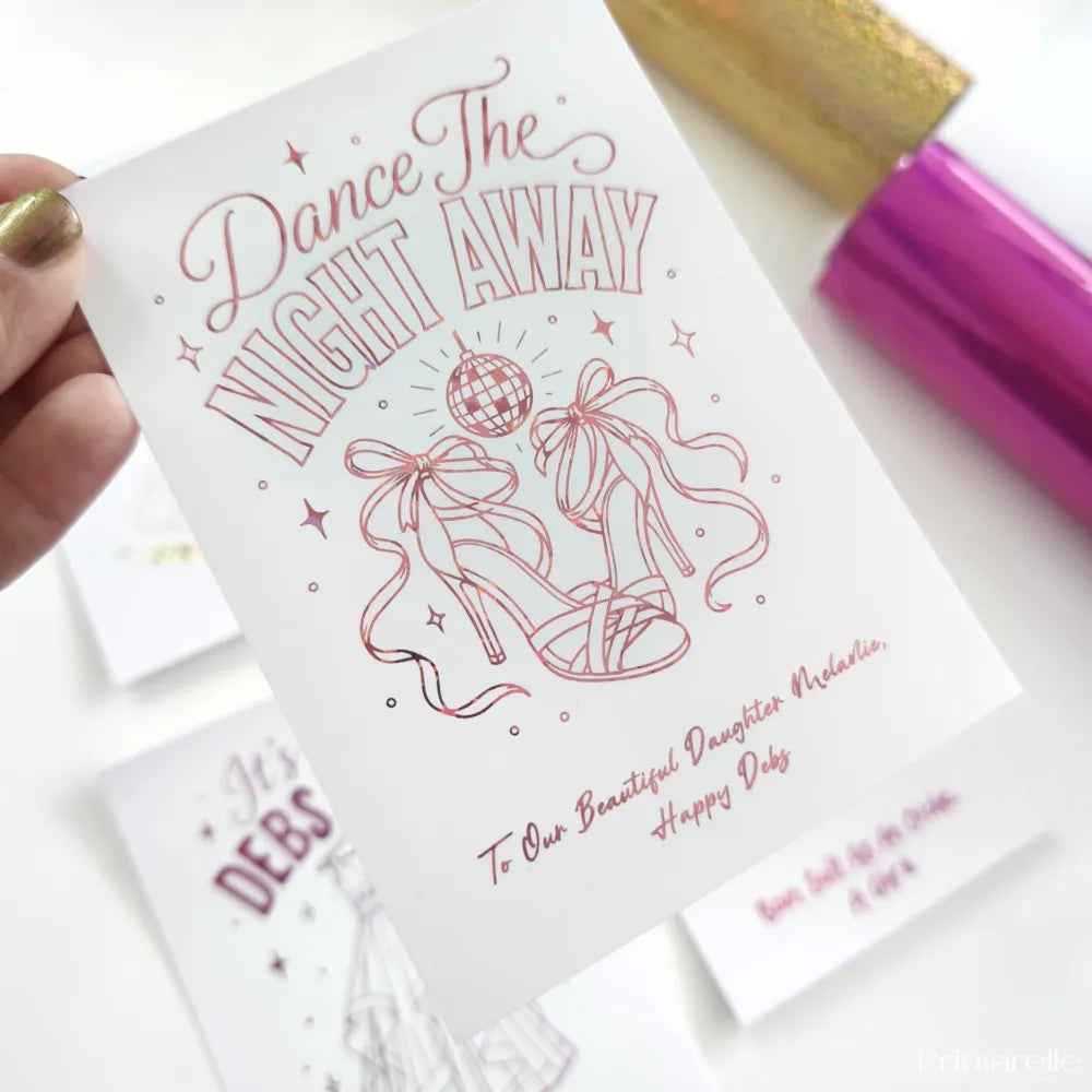 A white debs card with pink glitter foil heels disco ball and dance the night away text for a daughter party