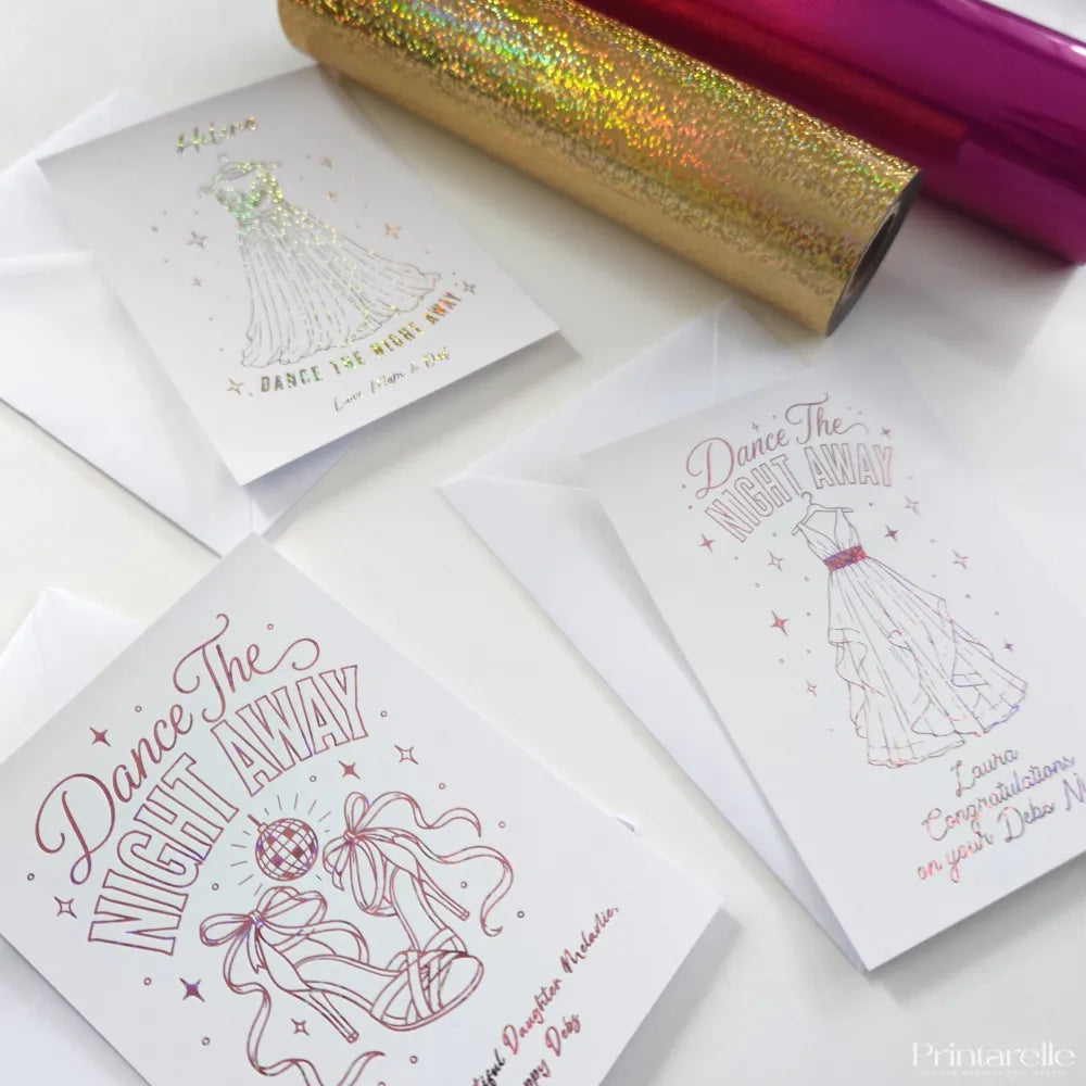 White debs card featuring elegant pink foil dresses and heels with dance the night away in holographic blue foil design