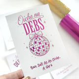 A white debs card with pink text and a checkered disco ball featuring holographic blue foil for debs night celebration