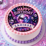 A pink and purple frosted birthday cake with a glittering disco ball cake topper and a personalised icing sheet banner says saoirse
