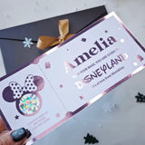 Personalized Disney-themed gift bag with 'Amelia' and 'Disneyland' text, featuring a bow on a light gray background.