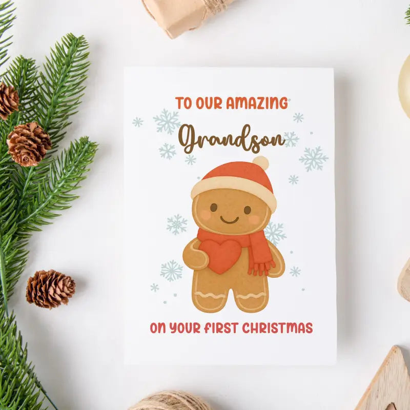 Greeting card with a gingerbread man illustration and text for an amazing grandson on their first Christmas, surrounded by Christmas decorations.