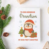 Christmas card with a penguin and text for a grandson on a white background with festive elements.