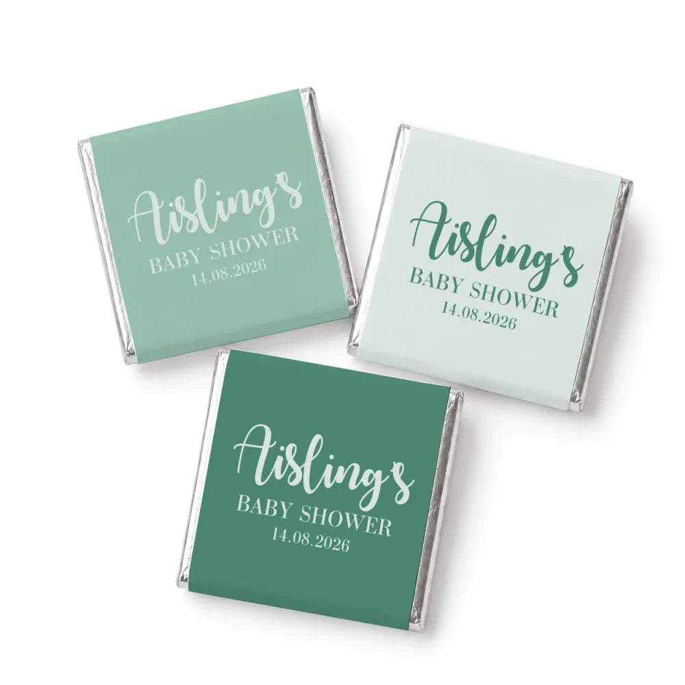 Three mini neapolitan chocolates with mint green and white elegant script labels on silver foil for baby shower favors