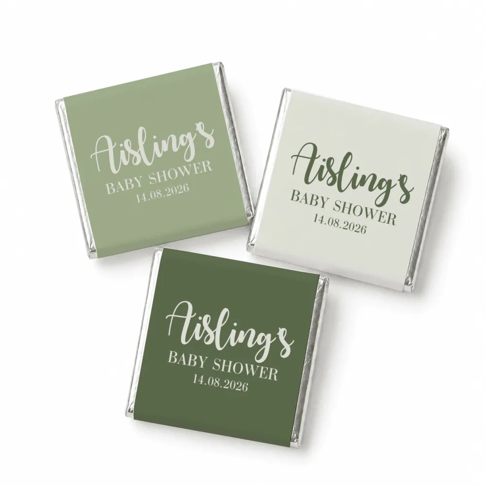 Elegant script mini neapolitan chocolates wrapped in matte green and off-white paper for a baby shower favor