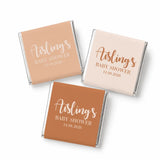 Three mini neapolitan chocolates wrapped with elegant script baby shower labels in pastel peach blush and terrac colors