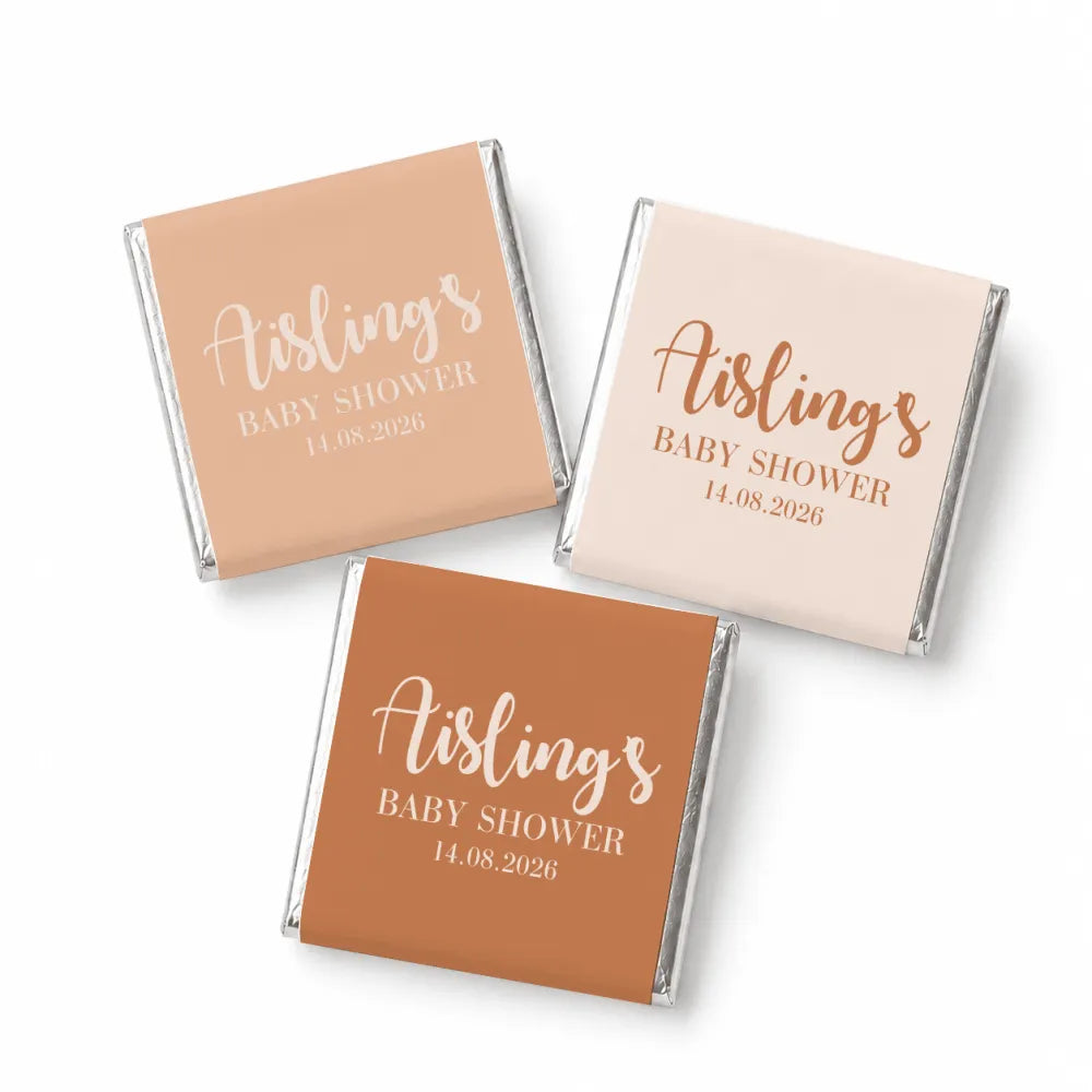 Three mini neapolitan chocolates wrapped with elegant script baby shower labels in pastel peach blush and terrac colors