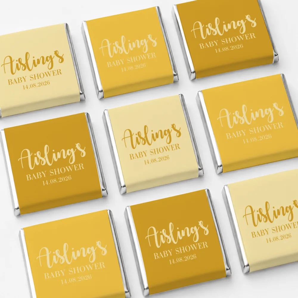 Elegant script mini neapolitan chocolates wrapped in gold and pale yellow foil for baby shower favours