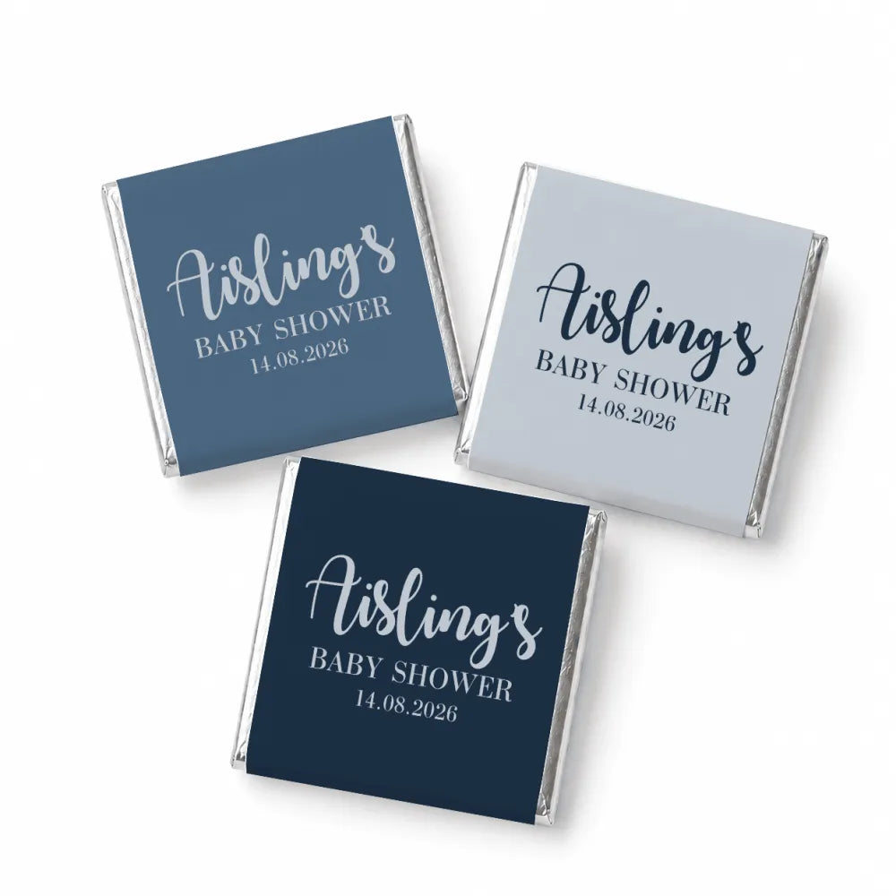 Three mini neapolitan chocolates individually wrapped in navy blue and gray foil for a stylish baby shower favor