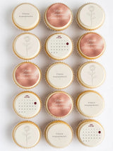 Delicate vanilla cupcakes with personalised engagement rose gold and white edible cupcake toppers celebrating love