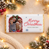 A personalized white chocolate bar with gold foil edges and a festive family photo chocolate bar wrap for christmas