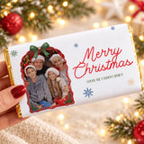 A white chocolate bar with a personalized family photo chocolate bar wrap in gold foil featuring christmas details