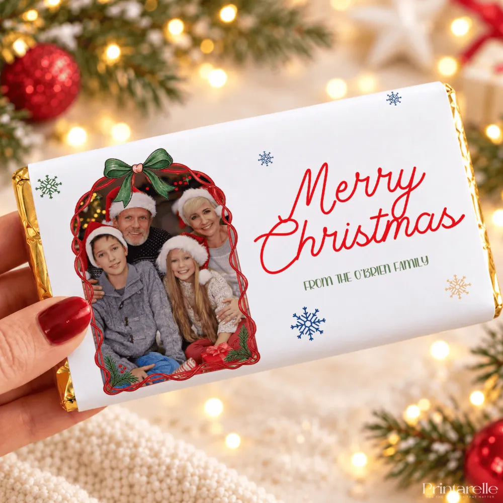 A white chocolate bar with a personalized family photo chocolate bar wrap in gold foil featuring christmas details