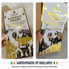 Two tickets for Santa's Train with festive design and text, held by a hand.
