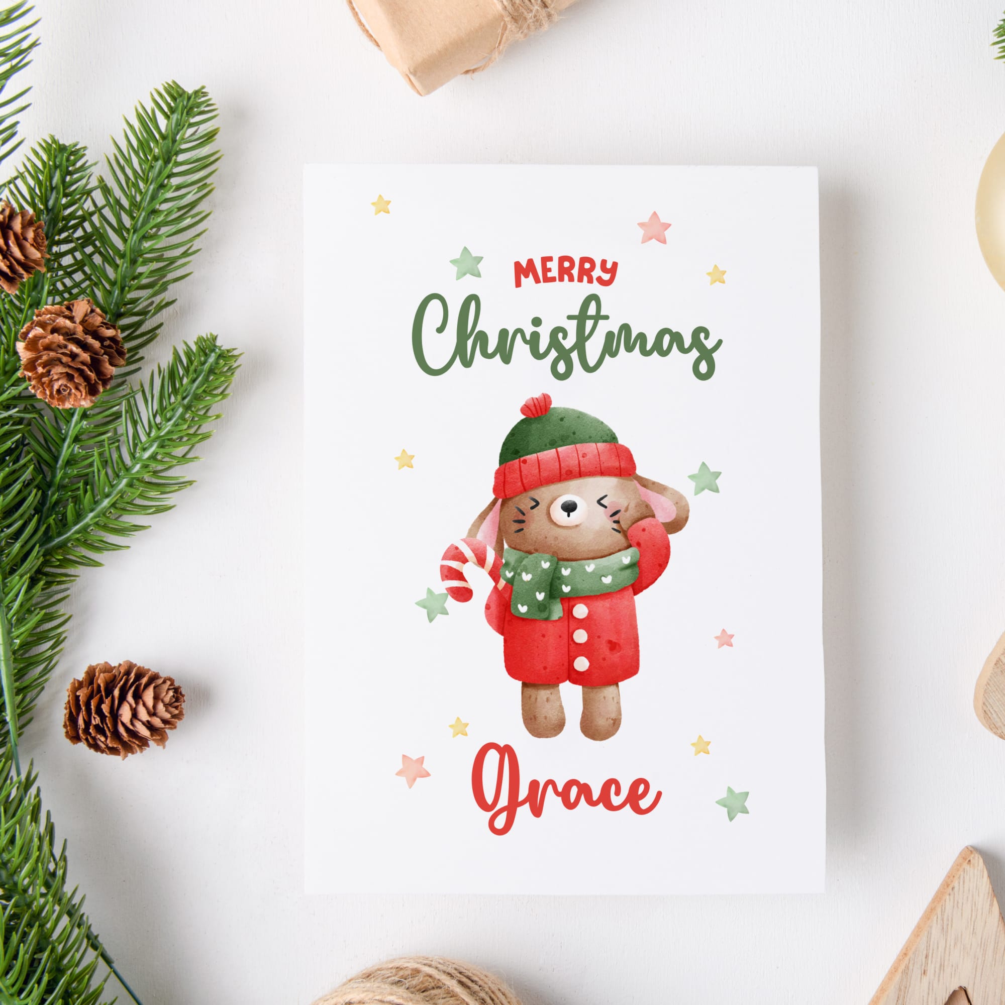 Christmas card with a cute bunny illustration and 'Merry Christmas Grace' text, surrounded by festive elements on a white background.