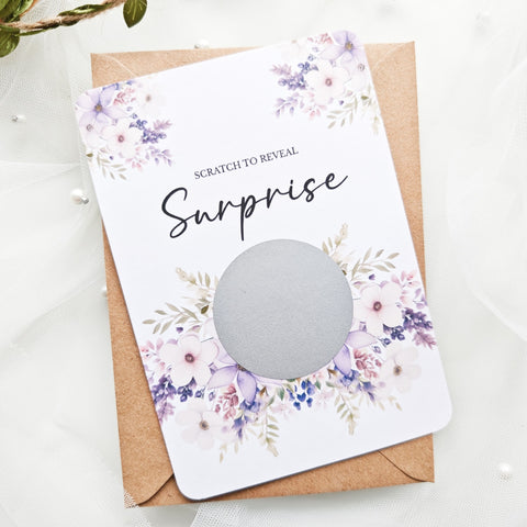Personalised scratch-to-reveal surprise card with floral design and hidden message for travel, pregnancy, or proposal.