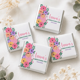 Pink floral-themed mini neapolitan chocolates in wrapped boxes for lauras christening day floral swaddle design