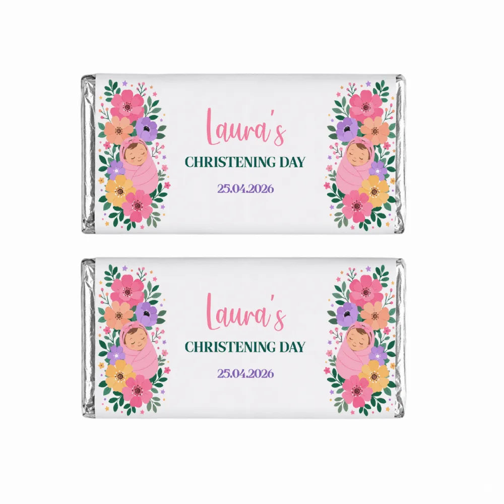 Two 40g chocolate bars wrapped in silver foil with floral swaddle labels featuring babies in pink blankets