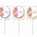Three colorful floral swaddle design christening lollipops wrapped in clear plastic with baby and personalized text
