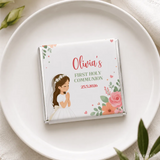 A personalized white chocolate mini neapolitan wrapped in silver foil with a girl in communion dress and floral design