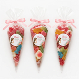 Three clear plastic floral veil communion sweet cones tied with pink ribbons and personalized olivia labels