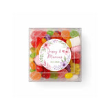 A clear box filled with colorful sugar-coated gummies and marshmallows perfect for floral wreath wedding dates