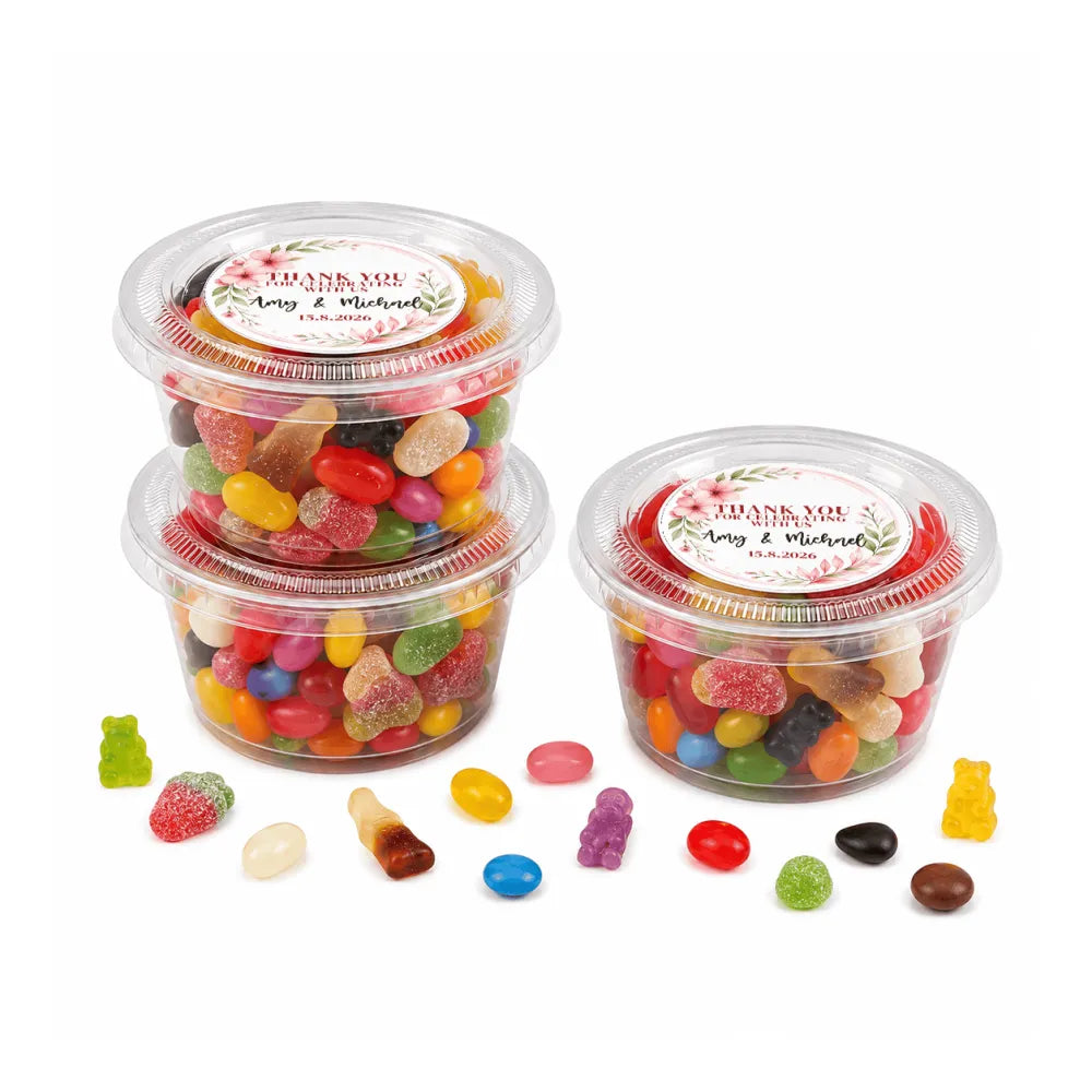 Clear plastic containers filled with colorful gummy candies and jelly beans in floral wreath foiled sticker sweet tub