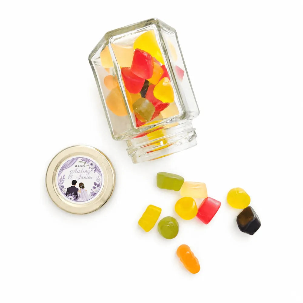 Clear glass jar with gold lid filled with colorful gummies for floral wreath wedding favours foil sticker hex jar