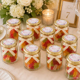 Clear glass hex jars with gold lids cream ribbons filled with colorful gummy bears wedding favours floral wreath design
