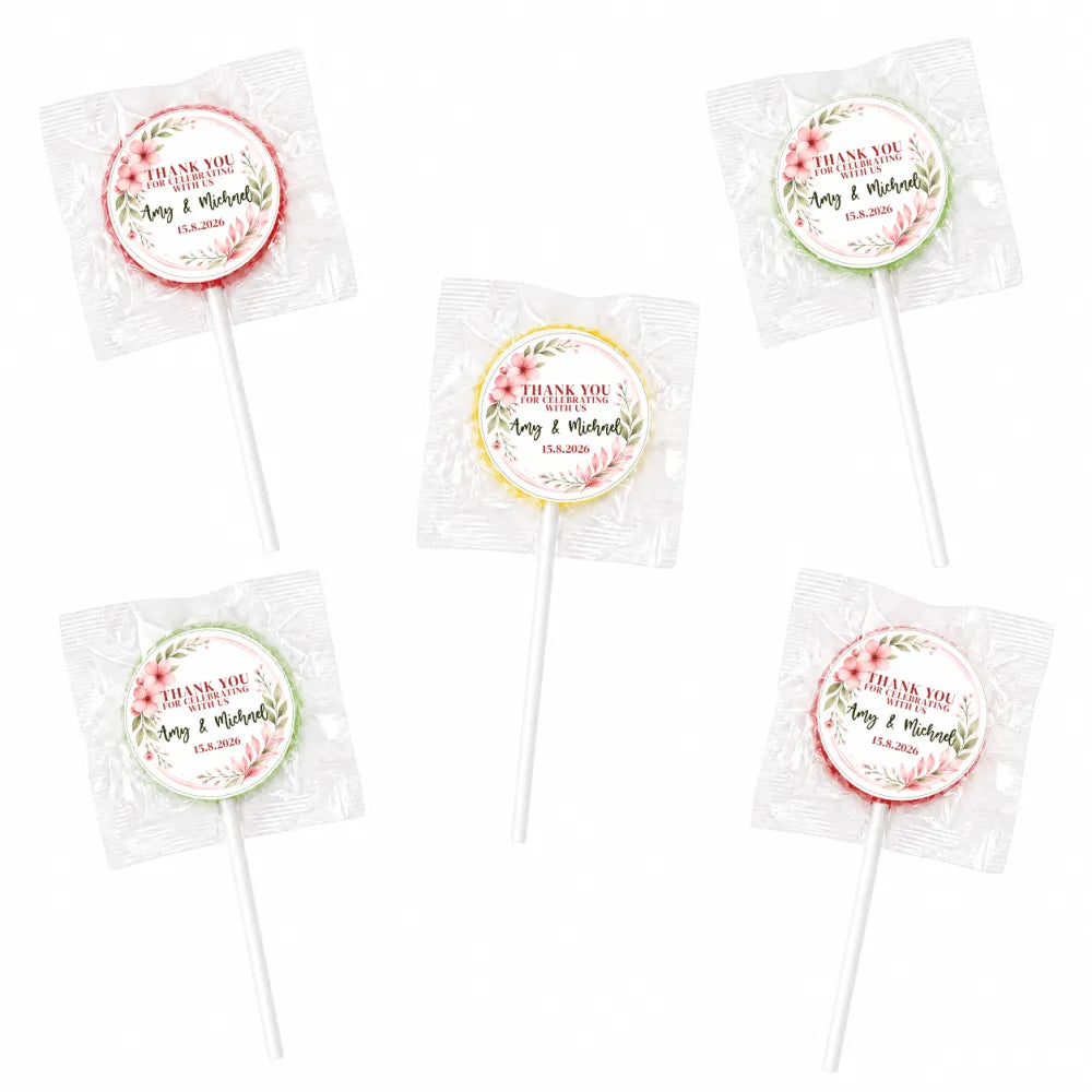 Pink and green floral wreath lollipop wedding favours wrapped in clear cellophane with foil sticker labels