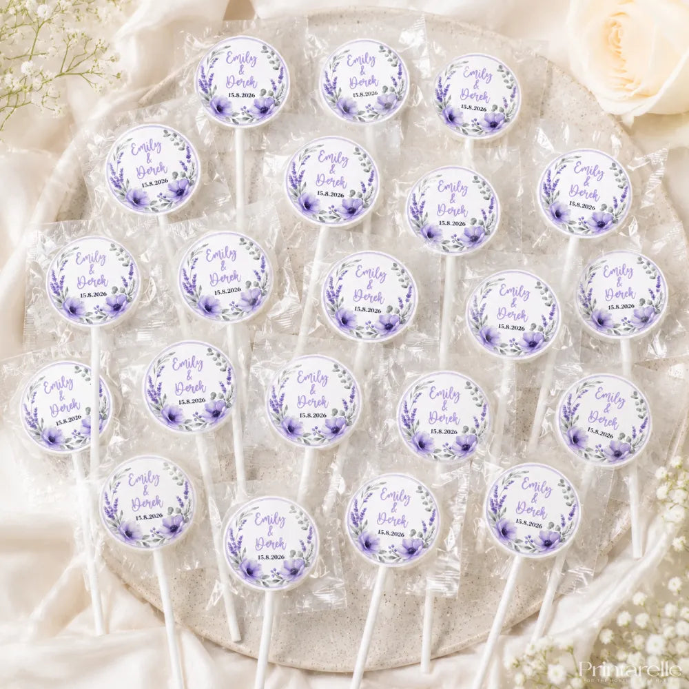 Purple and white lavender-themed lollipop wedding favours with floral wreath foil sticker labels wrapped fruit style