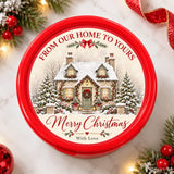 Red circular chocolate tub with snow-dusted cottage and christmas gifts message from our home to yours design