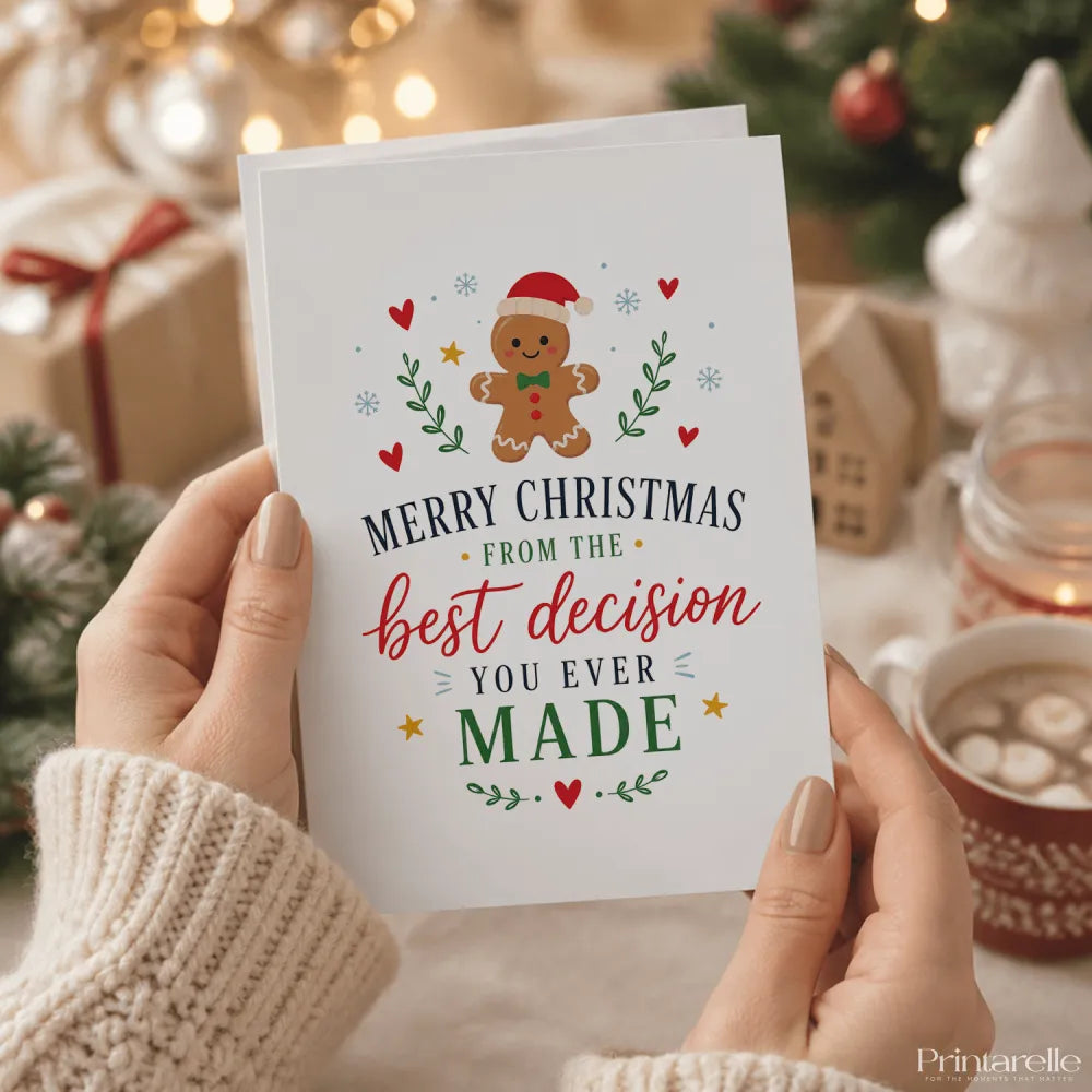 White christmas card featuring a smiling gingerbread man in red and green with hearts and snowflakes from your best decision