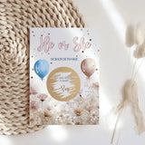 Gender reveal scratch card with balloons and flowers on a textured surface