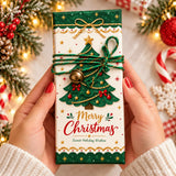 A festive green and white 100g chocolate bar with a gold bow red berries and a golden bell called gold bow tree