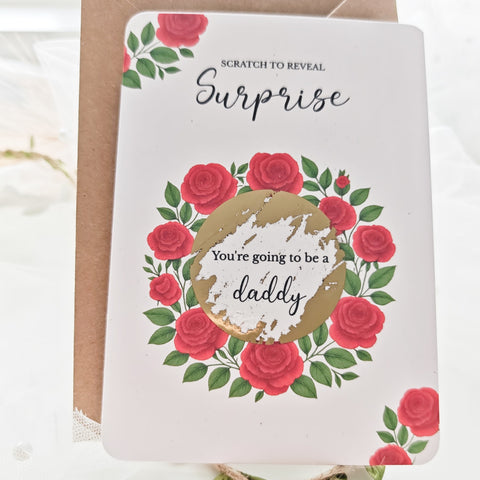 Flat lay of red rose scratch reveal card with gold sticker