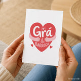 A white greeting card with a red heart and playful grá agus barróga text perfect for irish love and hugs