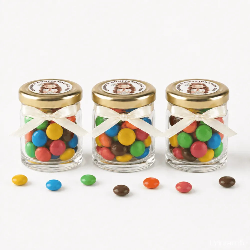 Three clear glass jars with 43mm pale gold lids and personalised sticker printed filled with colorful candy for confirmation favors