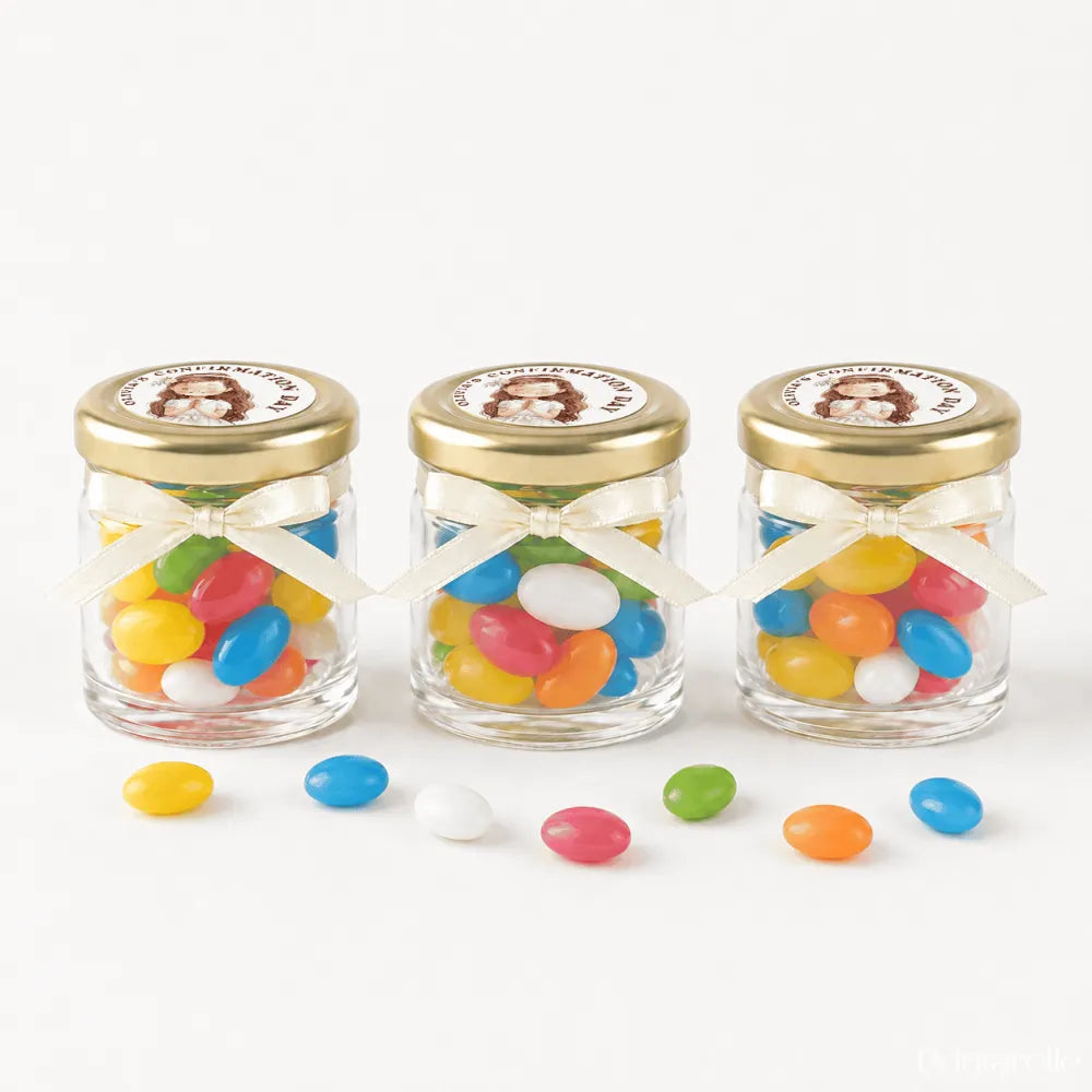 Three clear glass jars with 43mm pale gold lids and personalised sticker printed ribbons filled with jelly beans