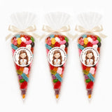 Three clear cellophane sweet cones tied with cream satin ribbons and praying girl stickers for olivias confirmation day filled with gummies