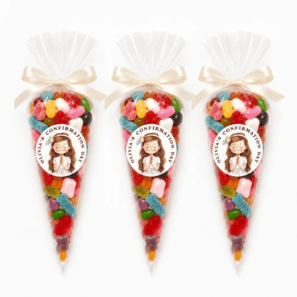 Three clear cellophane sweet cones tied with cream satin ribbons and praying girl stickers for olivias confirmation day filled with gummies