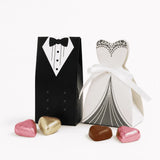 Black and white paper wedding favor boxes shaped like tuxedo and gown tied with ribbon perfect for chocolate hearts and lindt lindor mix