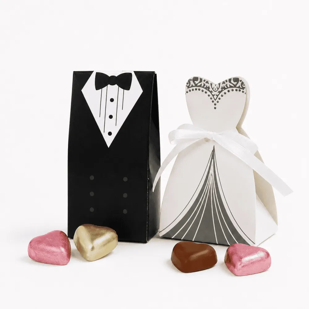 Black and white paper wedding favor boxes shaped like tuxedo and gown tied with ribbon perfect for chocolate hearts and lindt lindor mix