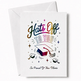 White graduation card with rainbow glitter foil lettering hats off to you and colorful mortarboard design