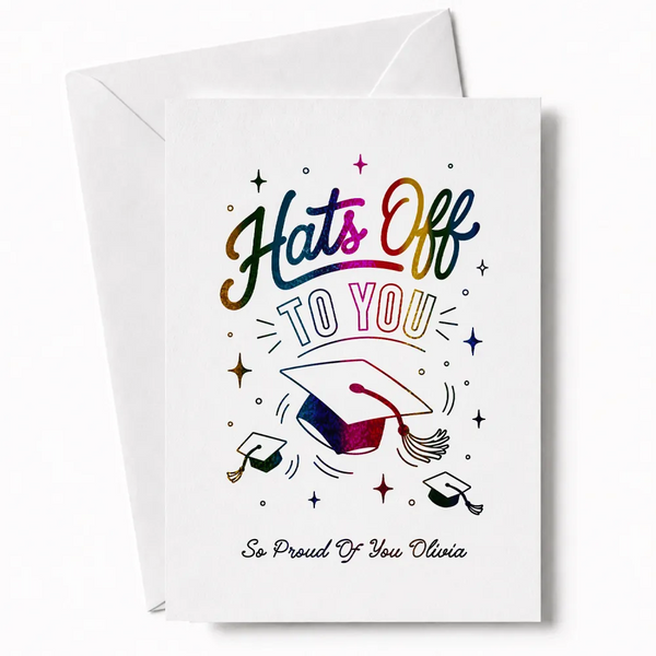 White graduation card with rainbow glitter foil lettering hats off to you and colorful mortarboard design