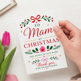 A festive white mam christmas card with red and green holiday illustrations and the message to mom at christmas